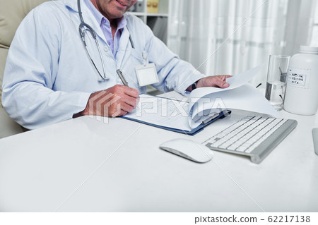 Doctor filling medical history Doctor filling medical history 62217138