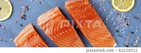 Raw salmon with lemon panorama, top shot with salt and pepper 62218512