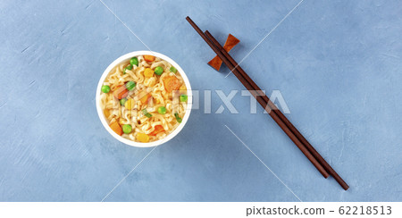 Ramen cup panorama, instant soba noodles in a plastic cup, shot from above with chopsticks and a place for text, a flatlay 62218513