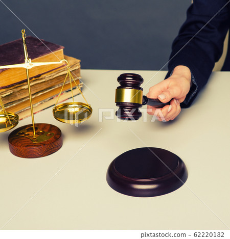 Cropped image of judge giving verdict by hitting 62220182