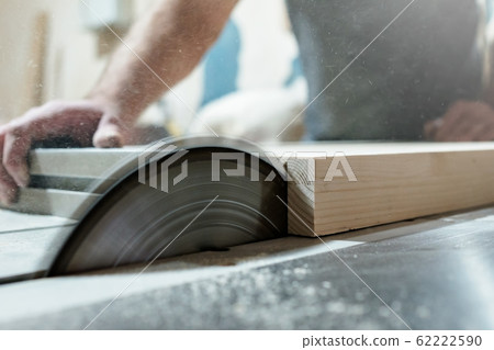 Caucasian man carpenter cutting wood with circular saw creating new furniture 62222590