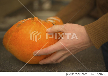 A man holds a mouldy pumpkin. A man holds a mouldy pumpkin. 62222872