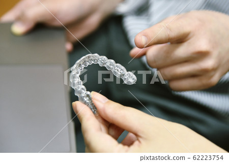 Inivisalign braces or aligner. Dentist advice how invisible orthodontics. 62223754
