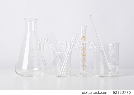 Group of scientific laboratory glassware with clear liquid solution. Group of scientific laboratory glassware with clear liquid solution. 62223770