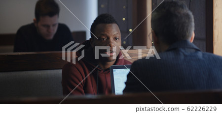 Businessman talking with client in cafe Businessman talking with client in cafe 62226229