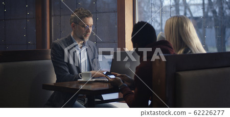 Young man showing smartphone to businessman Young man showing smartphone to businessman 62226277