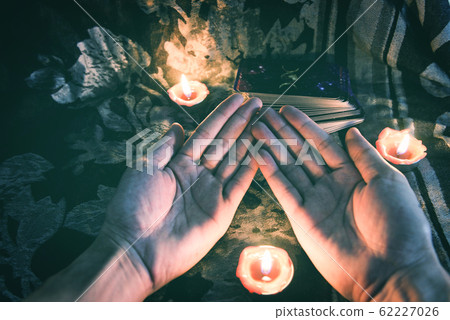 Fortune teller reading fortune lines on hand 62227026