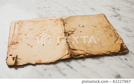 Opened vintage book on marble table with blank pages Opened vintage book on marble table with blank pages 62227967