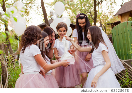 Young bride opens the gift box at girls party 62228678