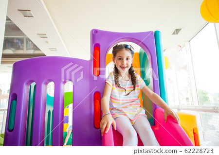 Excited cute girl playing in play centre on a vacation 62228723