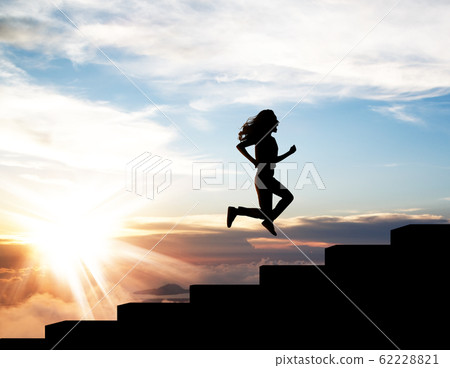 Black silhouette of woman running up on the staircase in sunset. Black silhouette of woman running up on the staircase in sunset. 62228821