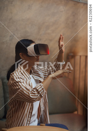 Young Asian Woman Enjoying VR Young Asian Woman Enjoying VR 62230694