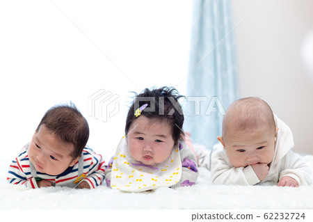 Three 3-month-old babies prone 62232724
