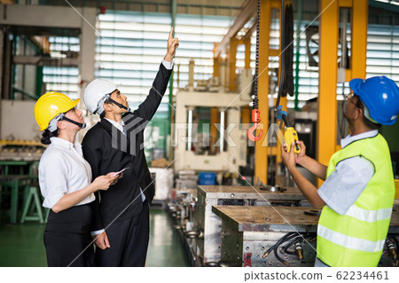 Factory manager command lifting crane in warehouse Factory manager command lifting crane in warehouse 62234461