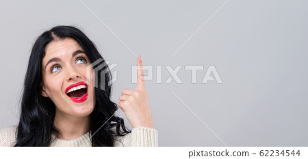 Young woman looking upwards Young woman looking upwards 62234544