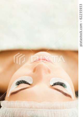 Eyelash extension procedure close up. Beauty concept 62235933