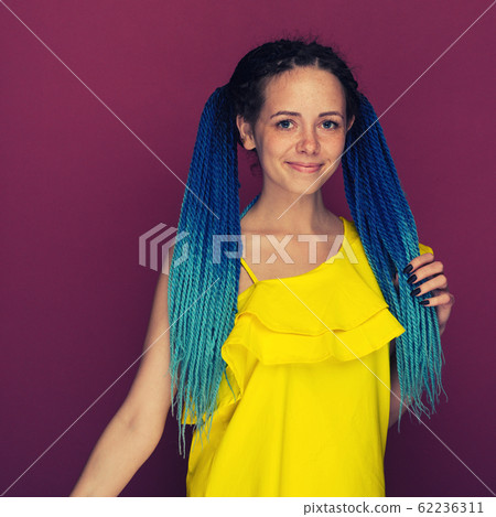 Portrait of a cheerful girl with freckles and blue Portrait of a cheerful girl with freckles and blue 62236311