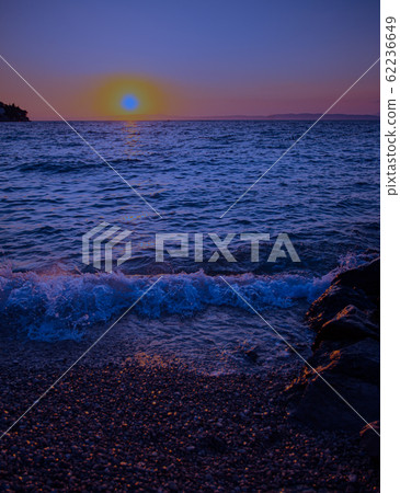 Sunset at the sea in the evening glow 62236649