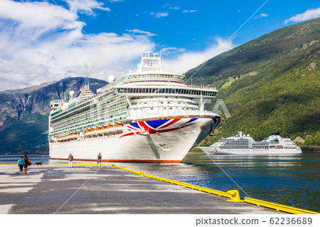 Luxury cruise ship departure in the port of Flam to Stavanger, in sunny summer day, Flam Norway. 25 July 2017. 62236689