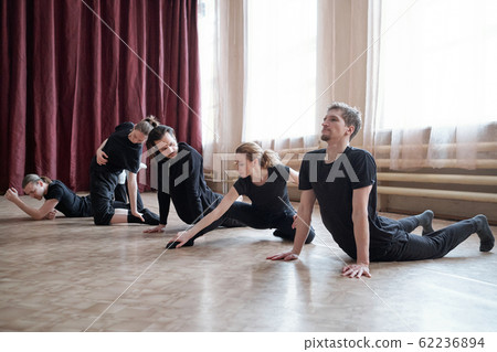 Professional Dancers Doing Stretching Exercise 62236894