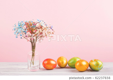 Easter concept with flowers and colored eggs on Easter concept with flowers and colored eggs on 62237838