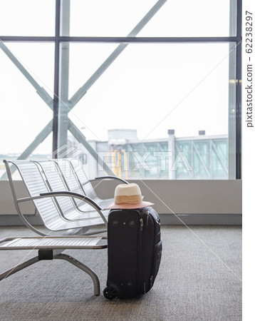 Suitcase in an airport waiting area, one black 62238297