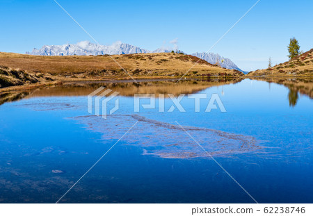 Autumn alpine Kleiner Paarsee or Paarseen lake, Land Salzburg, Austria. Alps Hochkonig rocky mountain group view in far. 62238746