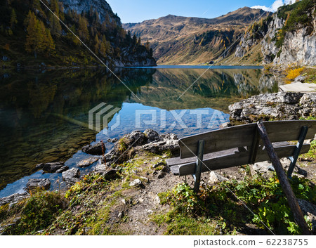 Sunny autumn alpine Tappenkarsee lake and rocky mountains above, Kleinarl, Land Salzburg, Austria. Sunny autumn alpine Tappenkarsee lake and rocky mountains above, Kleinarl, Land Salzburg, Austria. 62238755
