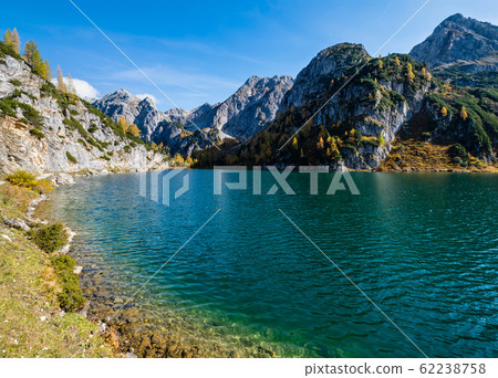 Sunny autumn alpine Tappenkarsee lake and rocky mountains above, Kleinarl, Land Salzburg, Austria. Sunny autumn alpine Tappenkarsee lake and rocky mountains above, Kleinarl, Land Salzburg, Austria. 62238758