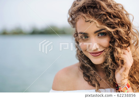Front view portrait of young woman standing outdoords in summer. 62238856