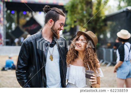 Young Couple At Summer Festival Walking Arm In Stock Photo