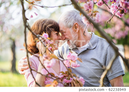 Beautiful senior couple in love outside in spring nature, hugging. Beautiful senior couple in love outside in spring nature, hugging. 62238949