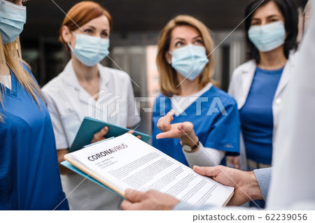 Group of doctors talking about corona virus on conference. 62239056