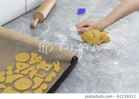 Women's hands roll out the dough. Preparation of dough, cookies, bread. Women's hands roll out the dough. Preparation of dough, cookies, bread. 62239312