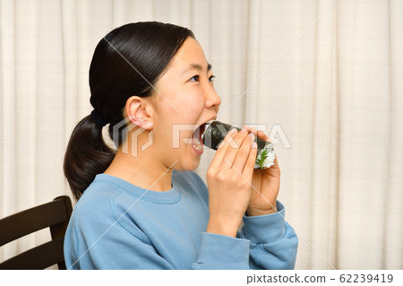 A girl eating Ehomaki (Setsubun) 62239419