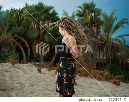 Young woman with dreadlocks over summer background Young woman with dreadlocks over summer background 62239545