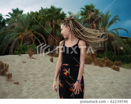 Young woman with dreadlocks over summer background Young woman with dreadlocks over summer background 62239546