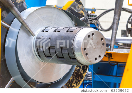 Industrial metal sheet coils connected with metal sheet profile forming machine. Industrial metal sheet coils connected with metal sheet profile forming machine. 62239652