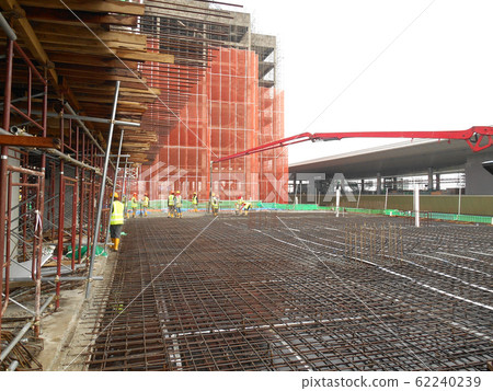 KUALA LUMPUR, MALAYSIA -JUNE 16, 2018: Floor slab and beam reinforcement bar under construction to form reinforcement concrete. Construction workers tied it together using tiny wires. KUALA LUMPUR, MALAYSIA -JUNE 16, 2018: Floor slab and beam reinforcement bar under construction to form reinforcement concrete. Construction workers tied it together using tiny wires. 62240239