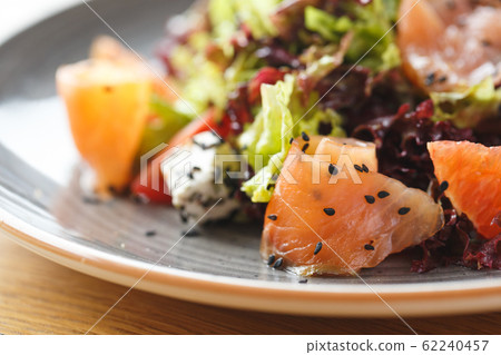 Lunch Time. Fresh salad with salmon and feta isolated on table ingredients close-up 62240457