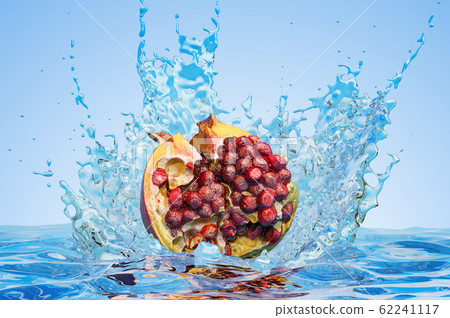 Pomegranate cut in half with water splashes 62241117