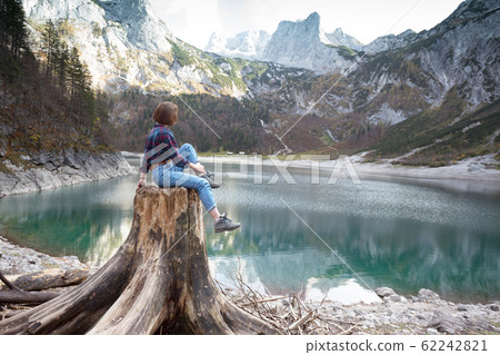 beautiful girl sitting on a stump beautiful girl sitting on a stump 62242821