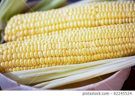 The cob of ripe cut corn sugar lies in a wicker 62245524