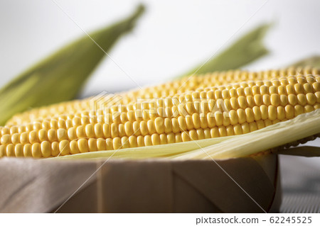 The cob of ripe cut corn sugar lies in a wicker 62245525