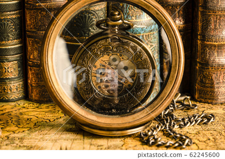 Antique clock on the background of a magnifying Antique clock on the background of a magnifying 62245600