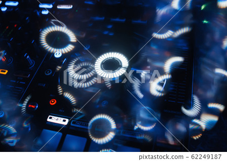 DJ mixer in a nightclub with glowing colored lights DJ mixer in a nightclub with glowing colored lights 62249187