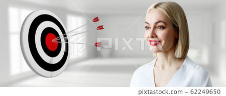 Businesswoman near archery target with arrows. Businesswoman near archery target with arrows. 62249650
