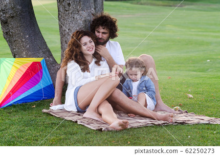 Happy young family in the park Happy young family in the park 62250273