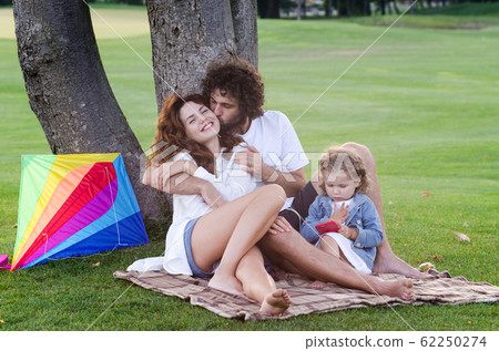 Happy young family in the park Happy young family in the park 62250274