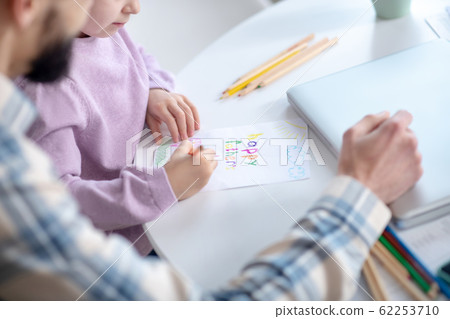 Little girl painting with dad at home. Little girl painting with dad at home. 62253710